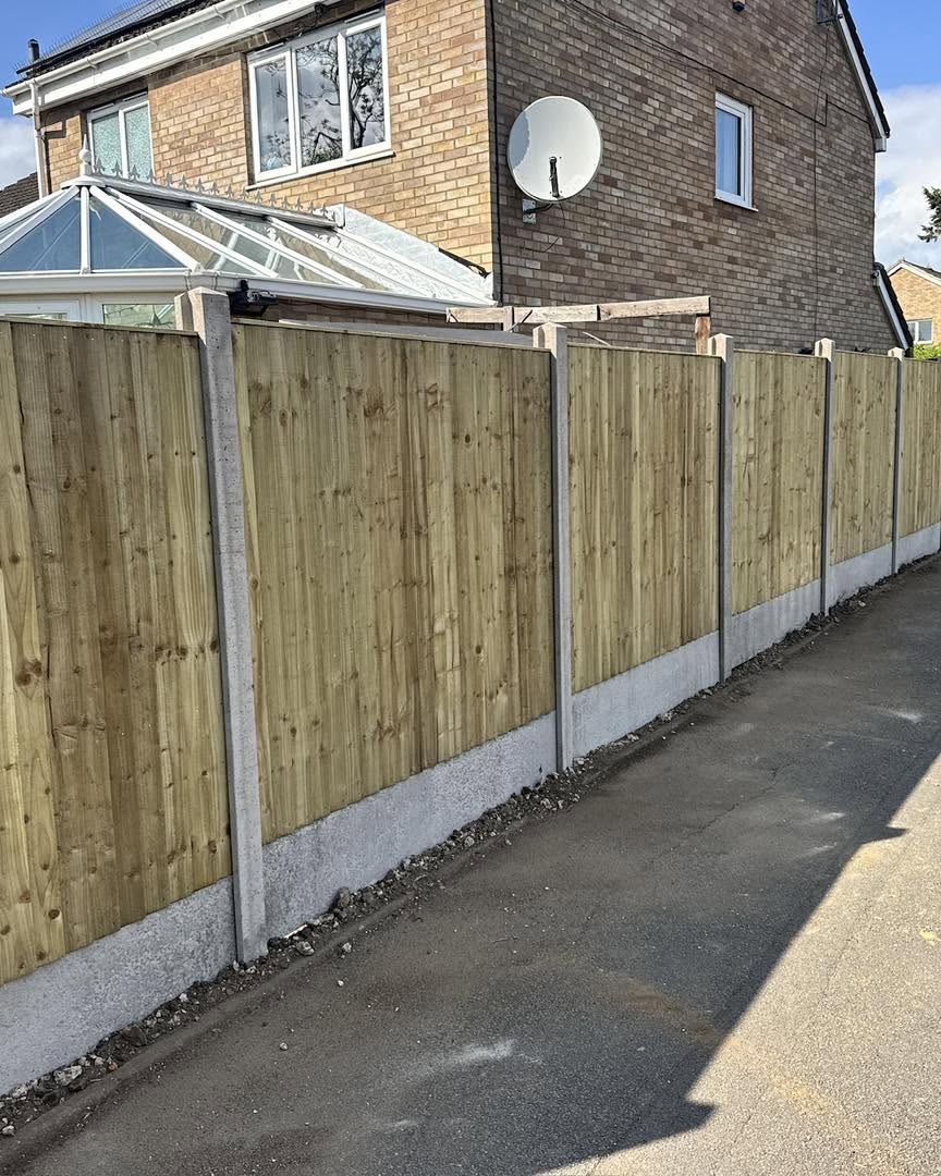Long timber fence with concrete posts