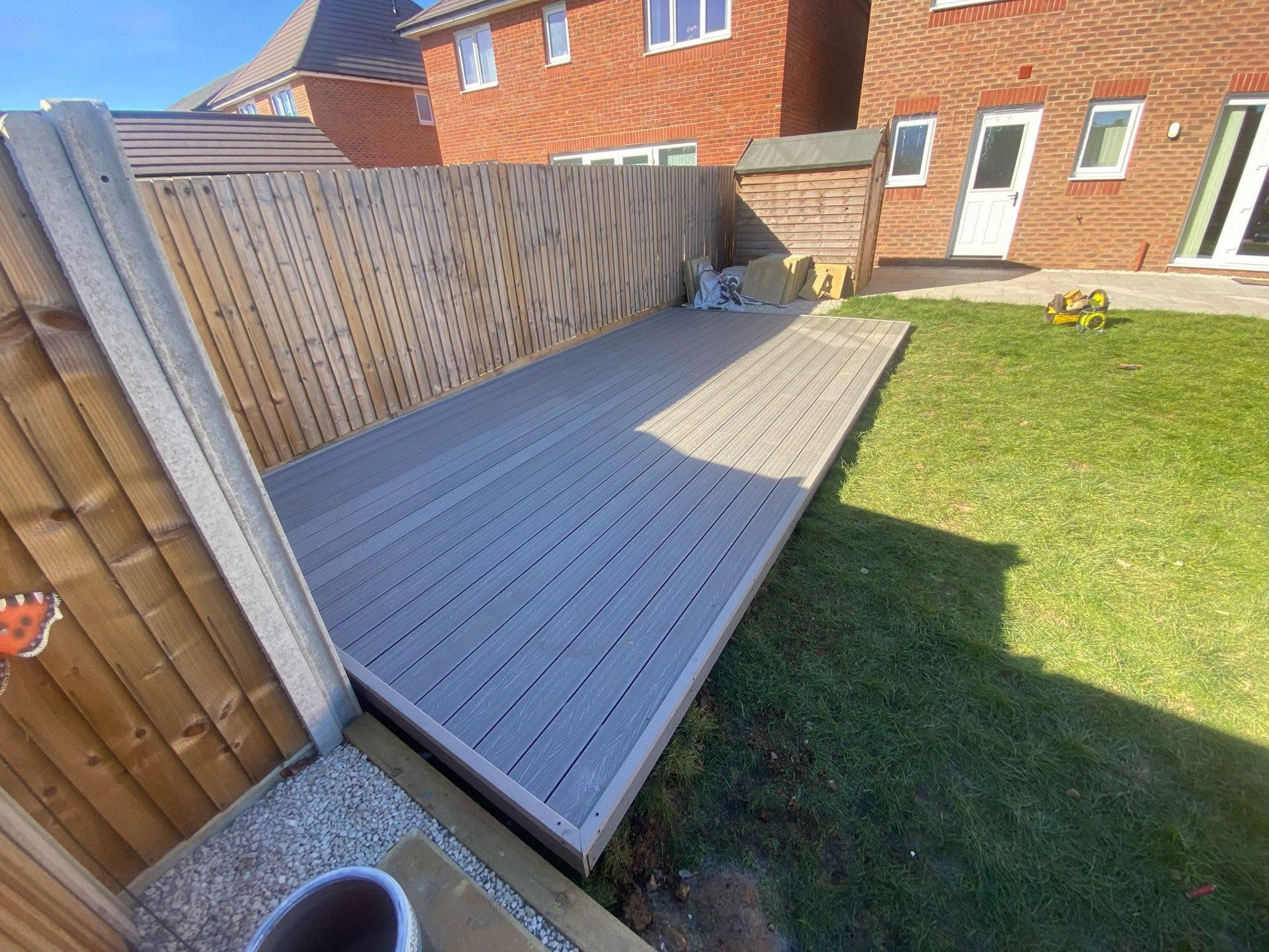 Composite deck alongside fence