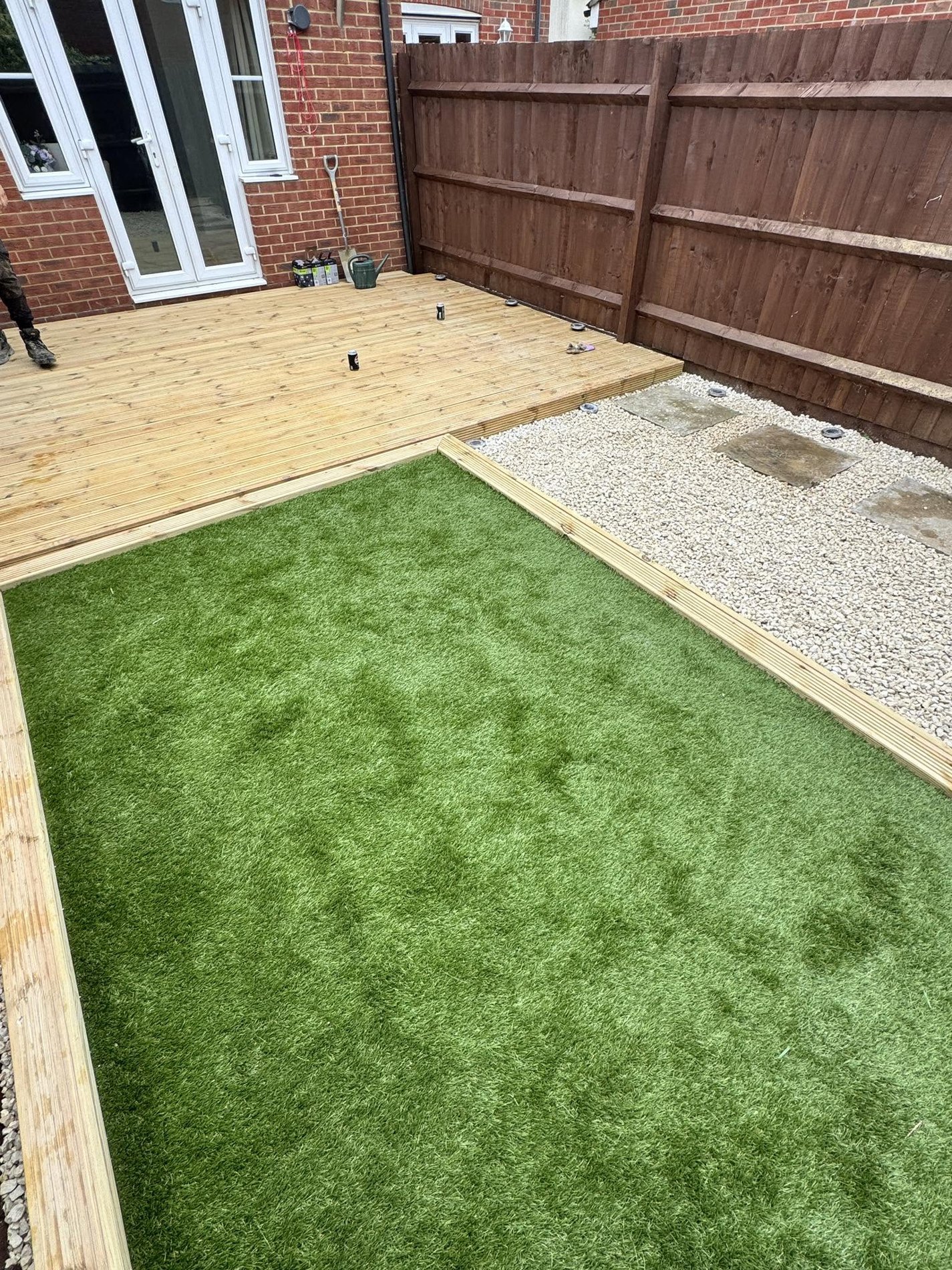 Timber decking beside artificial lawn